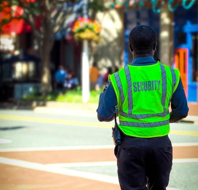 A security guard in a high-visibility vest on patrol.