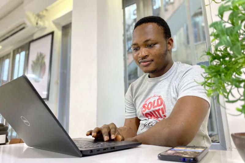 A man working on payroll on his laptop.